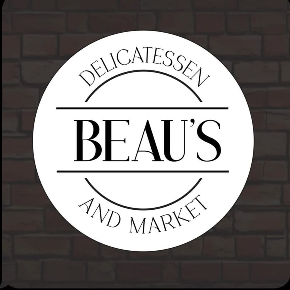 Beau's Delicatessen and Market logo, a white circle with black text on a brick background.